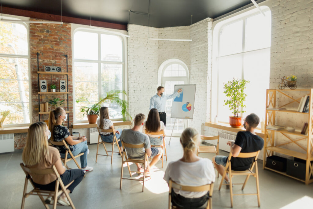 male-speaker-giving-presentation-hall-university-workshop-audience-conference-hall